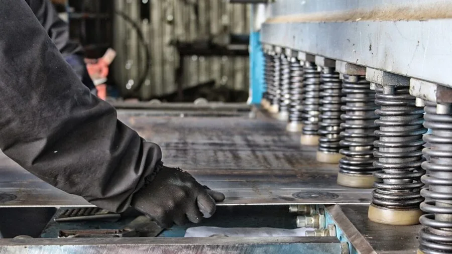 Professional examining metal fasteners and materials for construction project durability