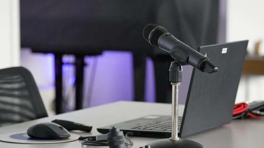 Professional home studio workspace with microphone and computer setup for content creation and recording