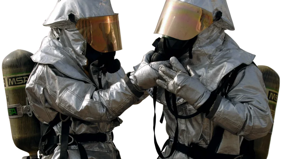 Professional in protective equipment performing hazardous material remediation work in industrial setting