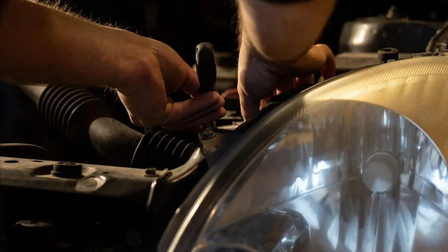 Professional mechanic performing vehicle maintenance service reset in auto repair shop