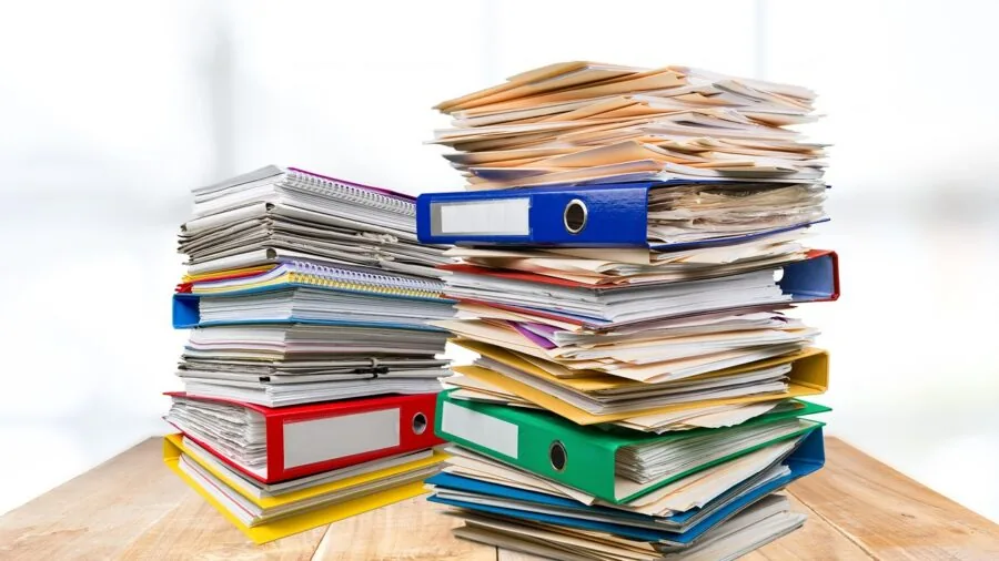 Professional organizing documents in a modern office workspace with filing systems and storage solutions