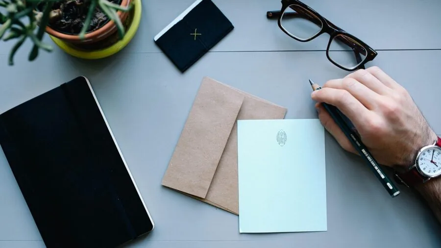 Professional organizing stacks of papers at a desk in a modern office workspace