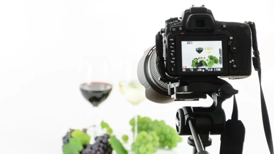Professional photographer carefully adjusting studio lighting stand and equipment in creative workspace