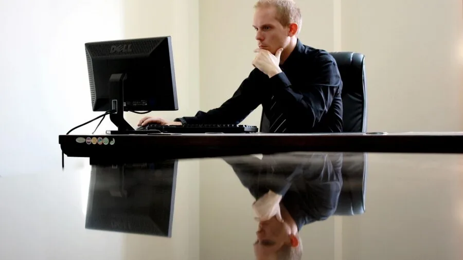 Professional relaxing in reclined office chair at desk during work break