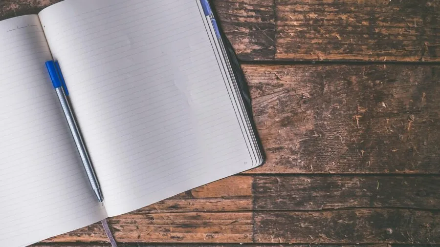 Professional reviewing high-quality printed documents and photos at home workspace