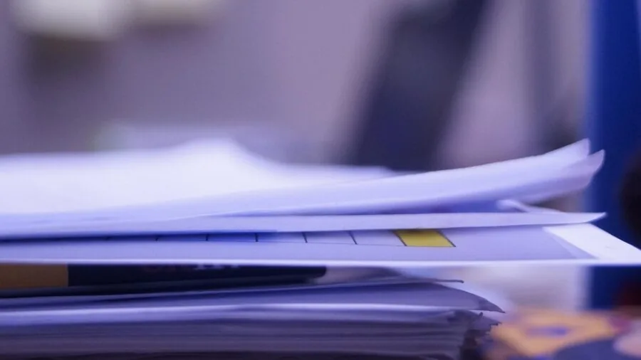 Professional scanning documents at desk in modern office workspace