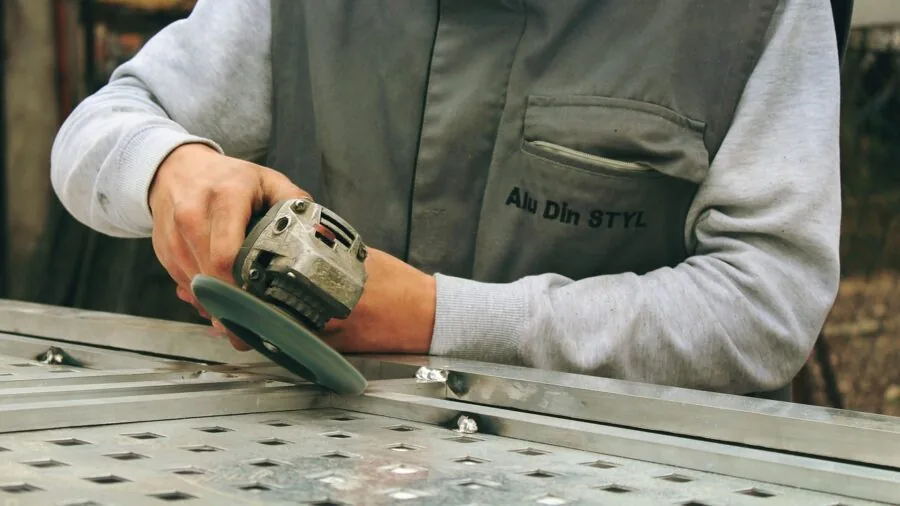 Professional tradesperson adjusting heat tool controls on job site