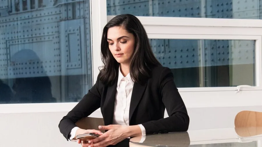 Professional woman in fitted blazer with padded shoulders demonstrating polished silhouette and proper tailoring fit