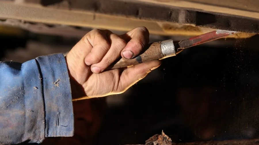 Professional worker handling oil and chemicals in industrial workshop setting