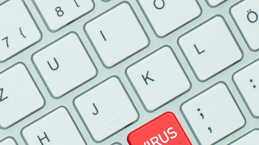 Professional working at desk monitoring cybersecurity threats on multiple screens
