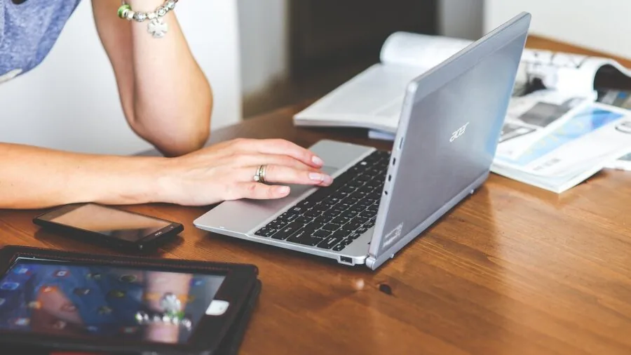 Professional working with laptop and wireless connectivity for data transfer and report generation