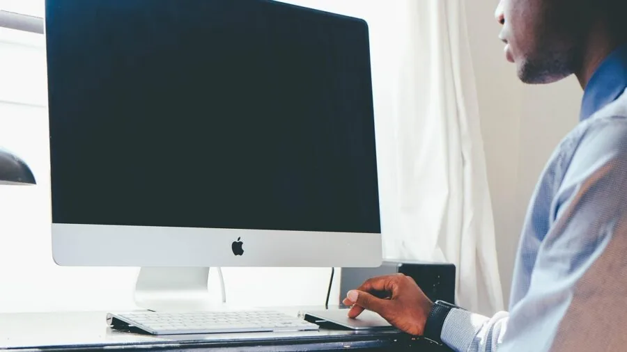 Professional workspace with curved ultrawide display showing ergonomic desk setup and comfortable working posture