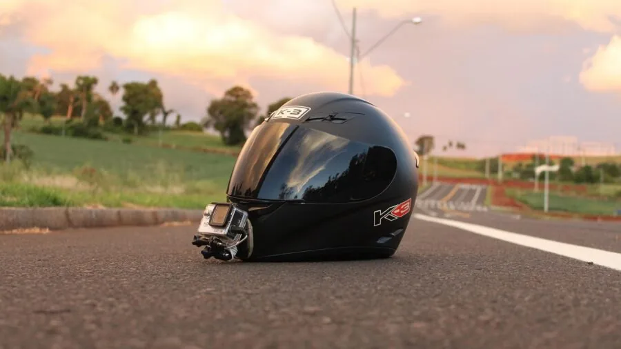 Properly fitted motorcycle cover on parked bike in driveway, protecting from elements