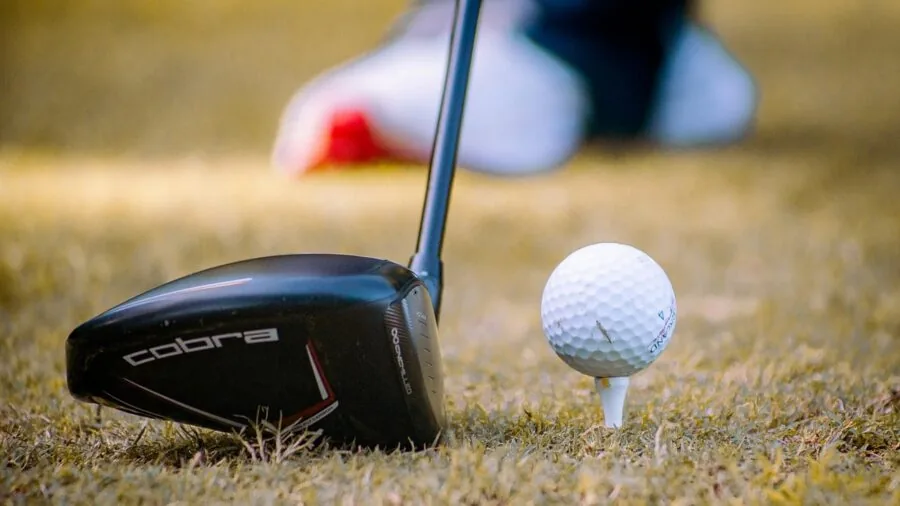 Recreational golfer demonstrating proper swing technique on golf course