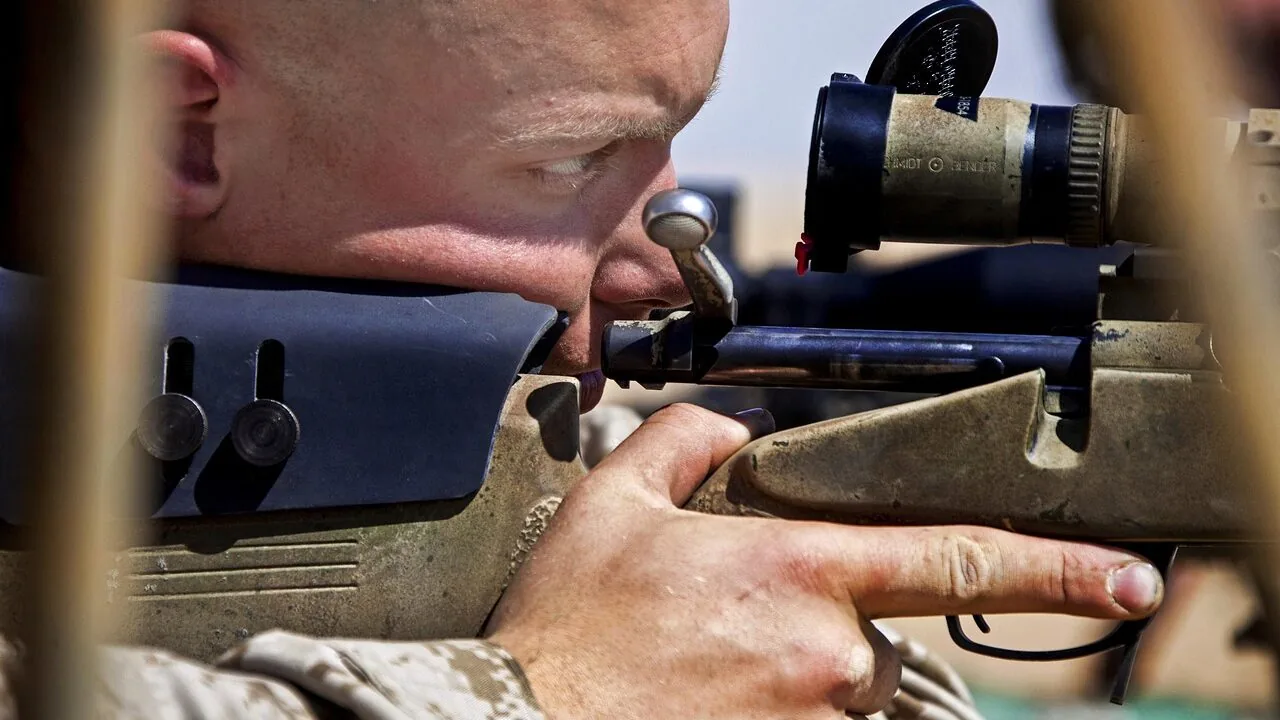 Red dot sight mounted on tactical rifle, close-up view