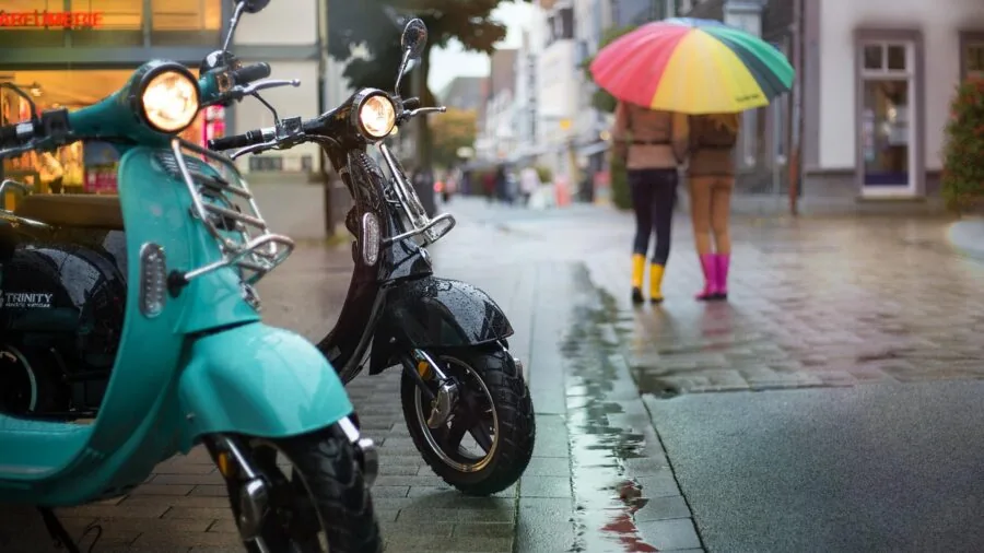 Rider demonstrating proper braking technique on electric scooter in urban setting