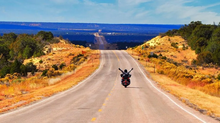Rider preparing motorcycle gear and equipment for extended touring journey