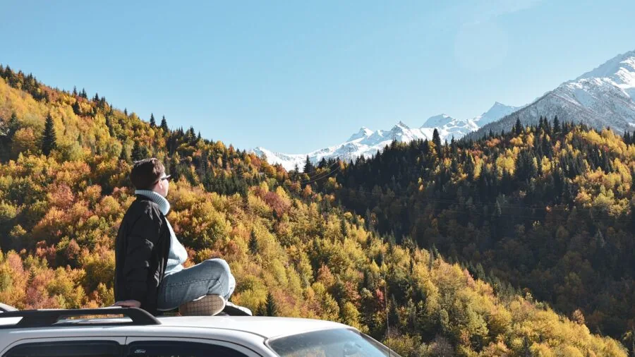 Road trip preparation with packed vehicle roof storage for family vacation journey