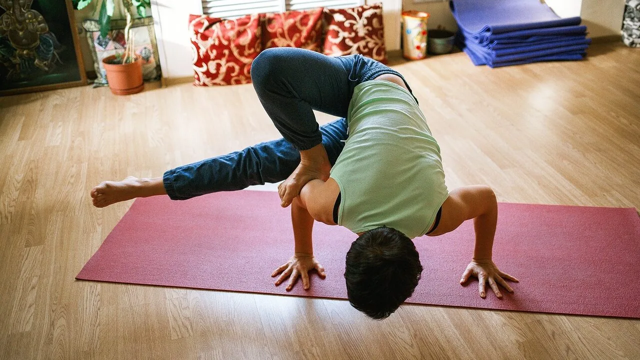 Rolled yoga mat on wooden floor in natural light