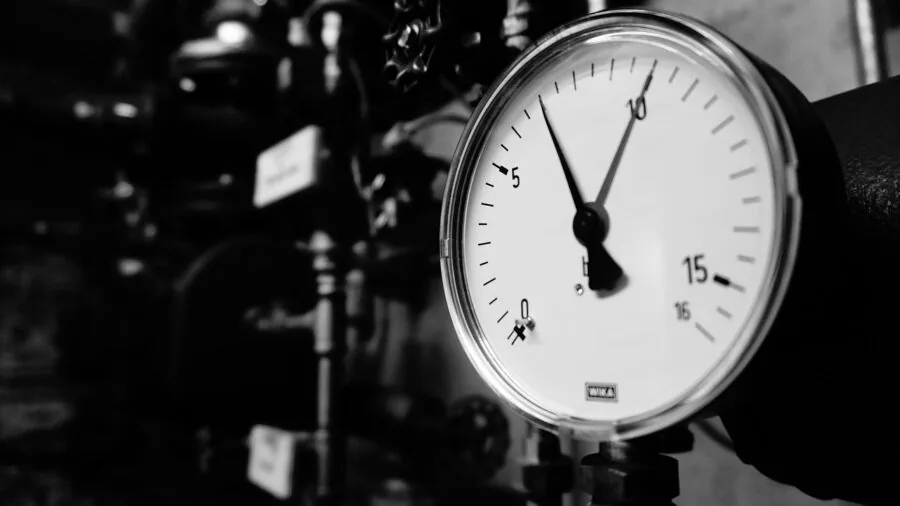 RV owner inspecting water pressure gauge during campsite setup