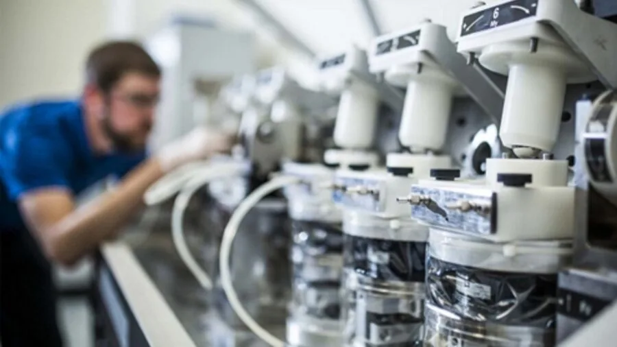 Scientist carefully adjusting precision measurement equipment in modern laboratory setting