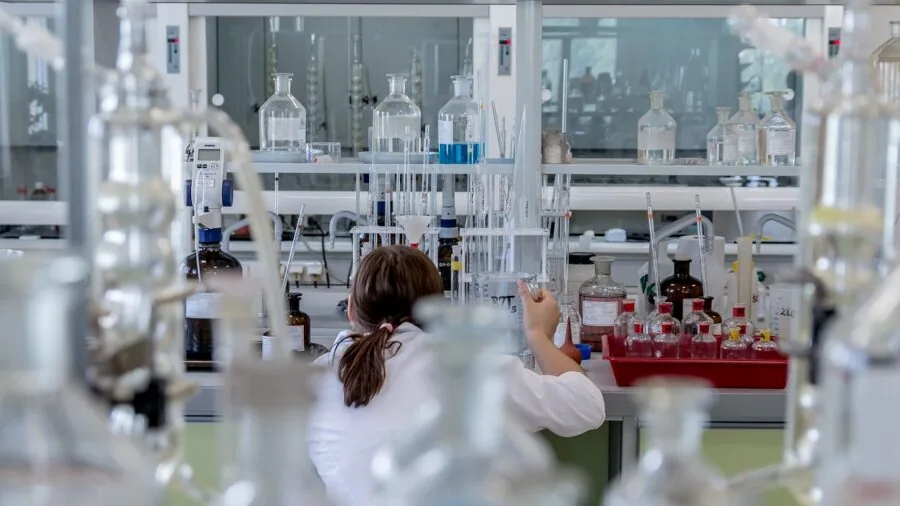 Scientist carefully measuring and recording precise measurements in a laboratory setting