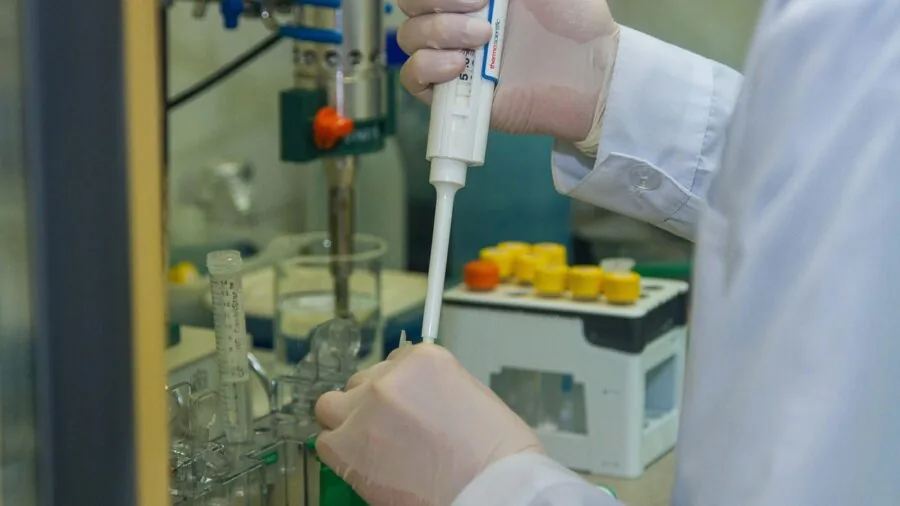 Scientist conducting temperature measurement experiment in professional laboratory setting