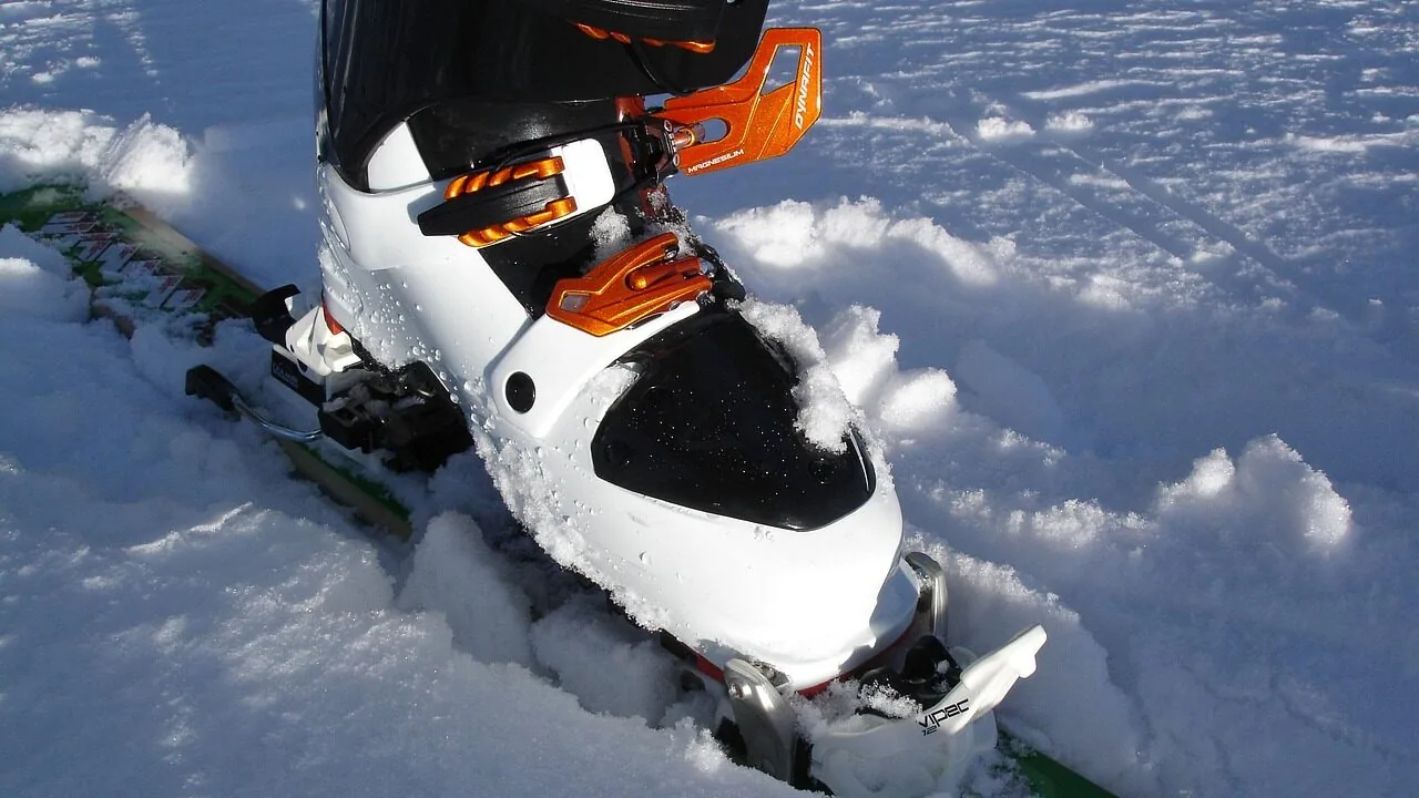 Ski bindings mounted on skis, showing binding mechanism and attachment detail