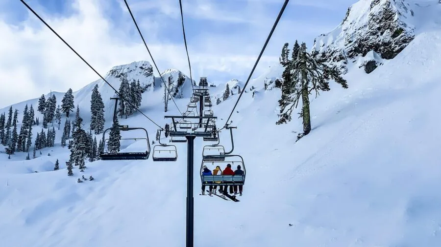 Skier in heavy snowfall wearing winter gear during snowy mountain conditions