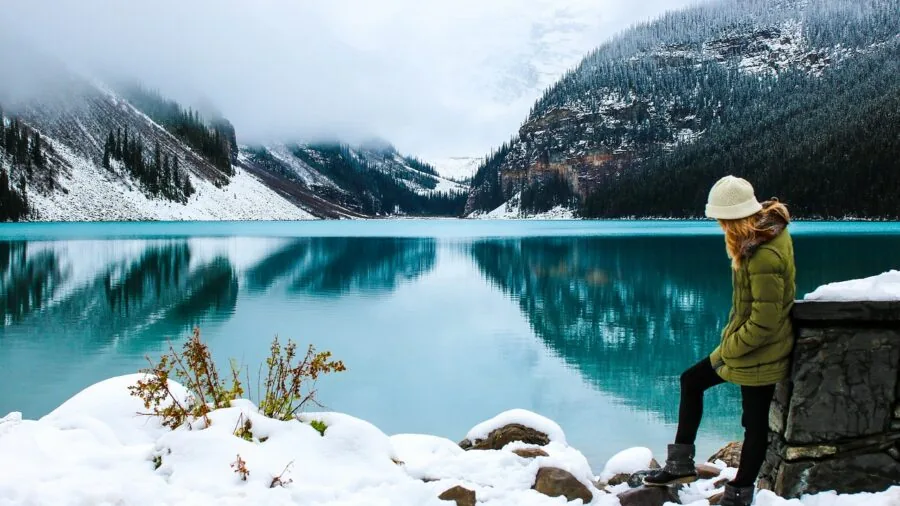 Skier in insulated jacket on snowy mountain slope during winter sports activity