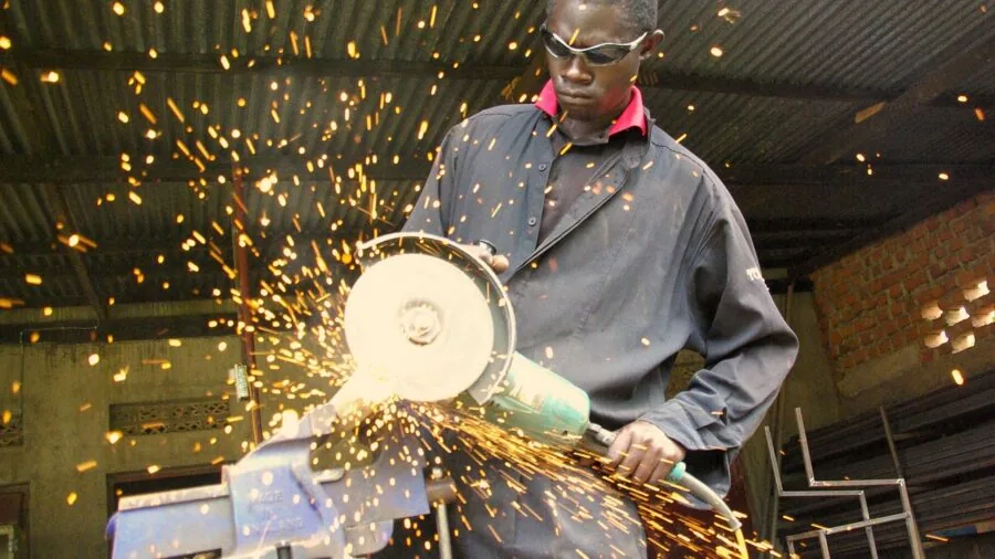 Skilled craftsman examining steel tool materials and build quality in workshop setting