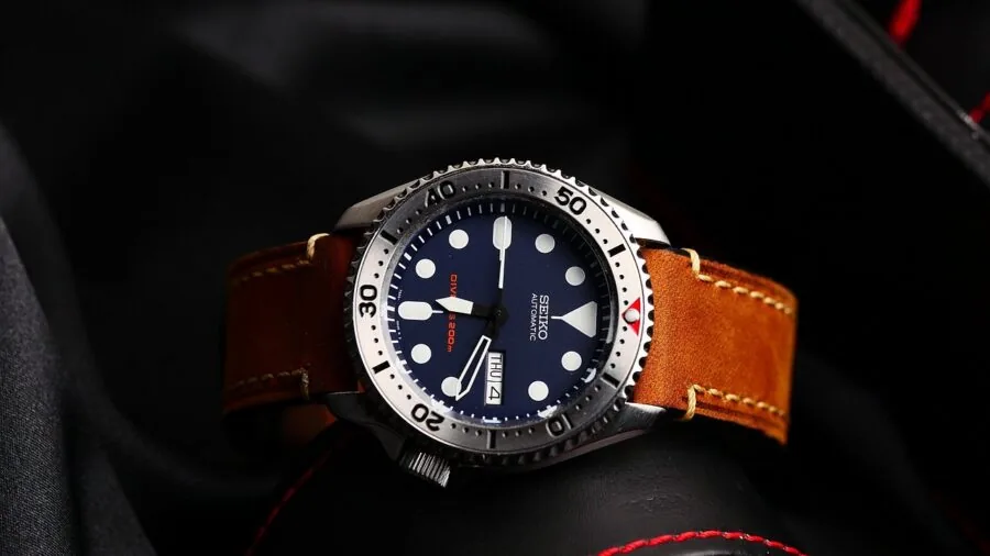 Skilled craftsperson inspecting delicate watch mechanism components with precision tools