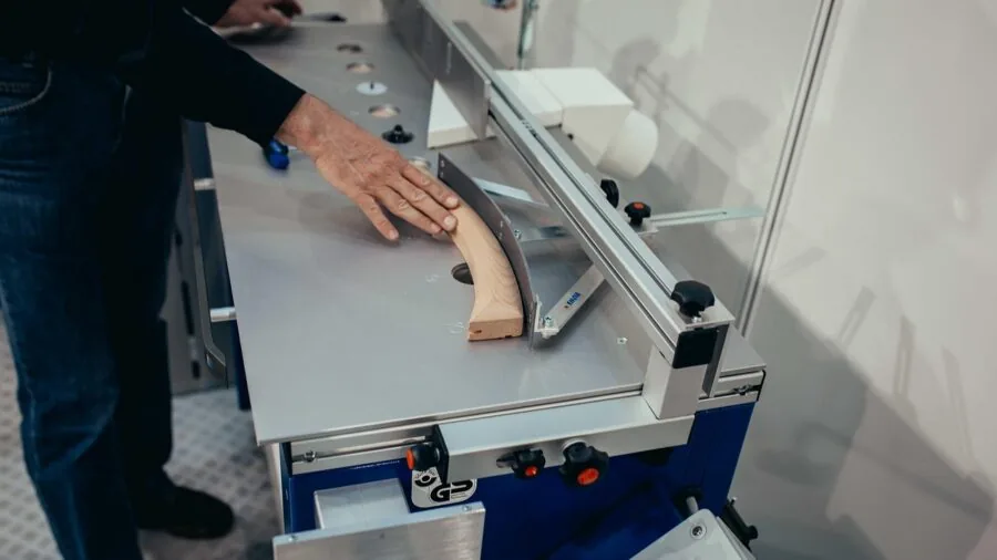 Skilled tradesperson using electric saw during home renovation project in workshop
