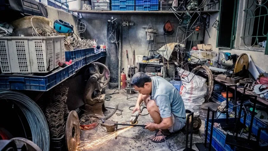 Skilled worker handling professional metal tools in workshop setting