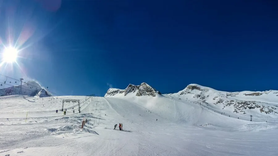 Snowboarder carving down snowy mountain slope in winter conditions