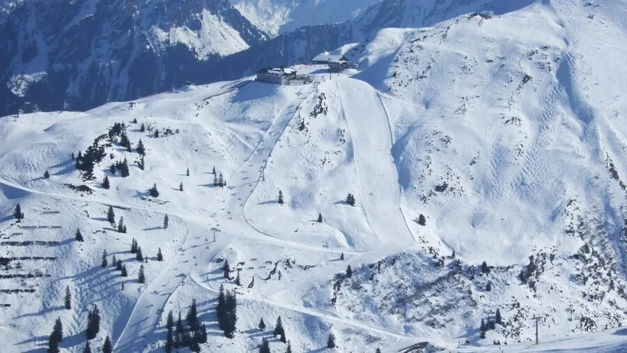 Snowboarder carving through fresh powder on a snowy mountain slope