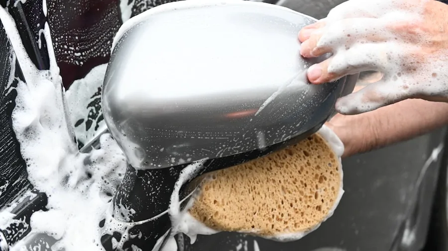 Someone carefully applying wax to a car's surface during a detail session
