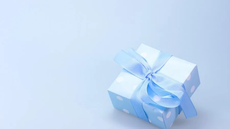 Someone carefully setting up a digital photo frame as a gift, depicting ease of use and thoughtful tech gifting