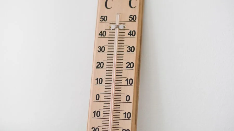 Someone checking their temperature with a digital thermometer during a health checkup at home