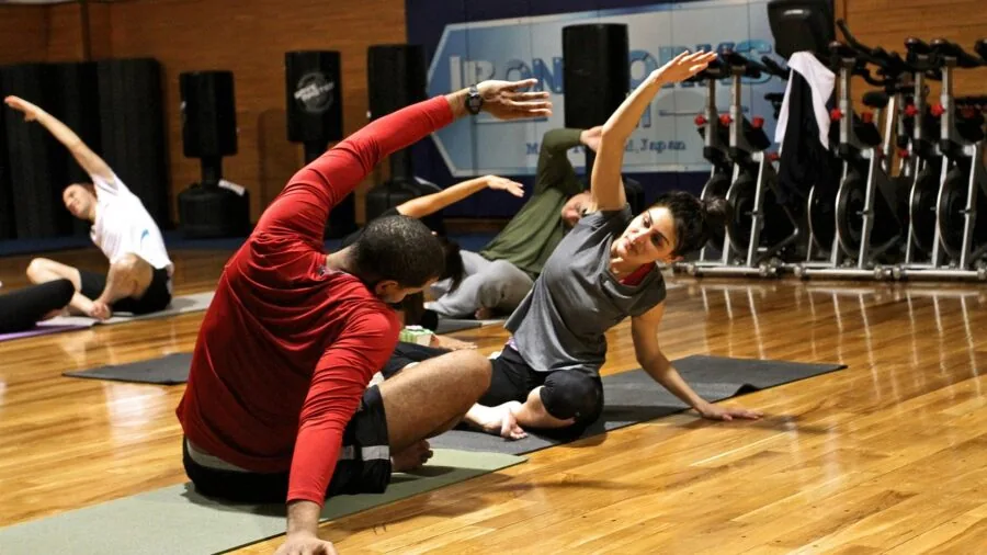 Someone doing a workout on a cushioned rubber gym floor mat indoors