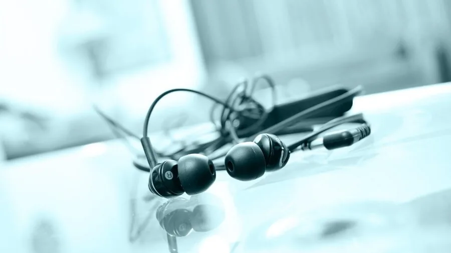 Someone enjoying high-quality audio through professional headphone equipment in a home studio setting