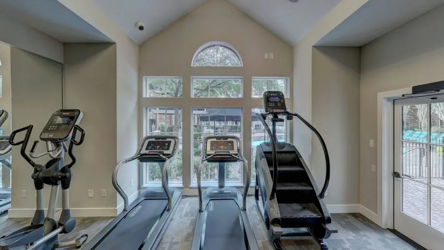 Someone installing a pull-up bar on a doorframe during home workout setup