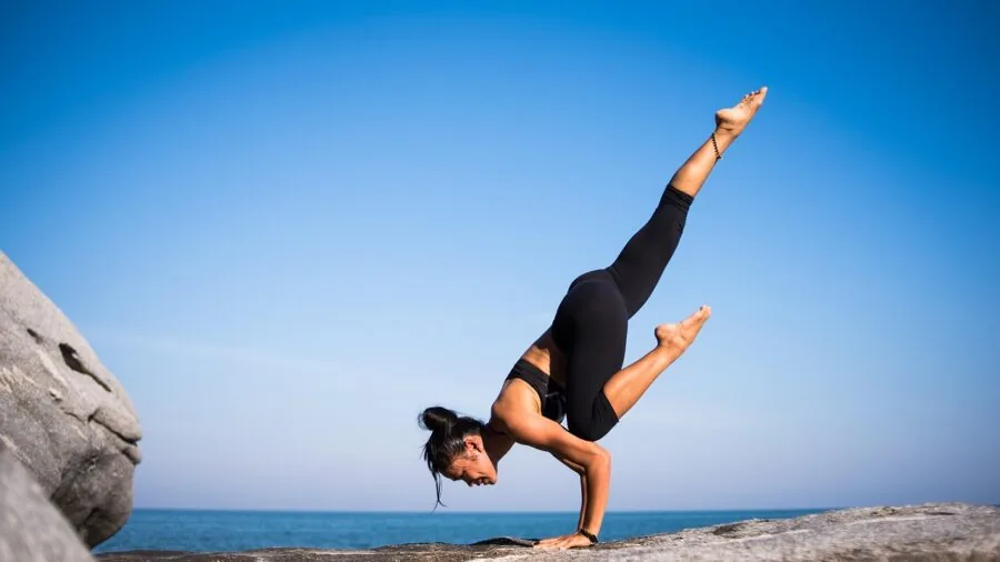 Someone practicing balance training on equipment during a workout session indoors