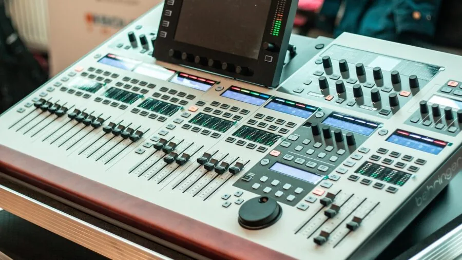Someone tuning audio settings on equipment in a home listening room environment