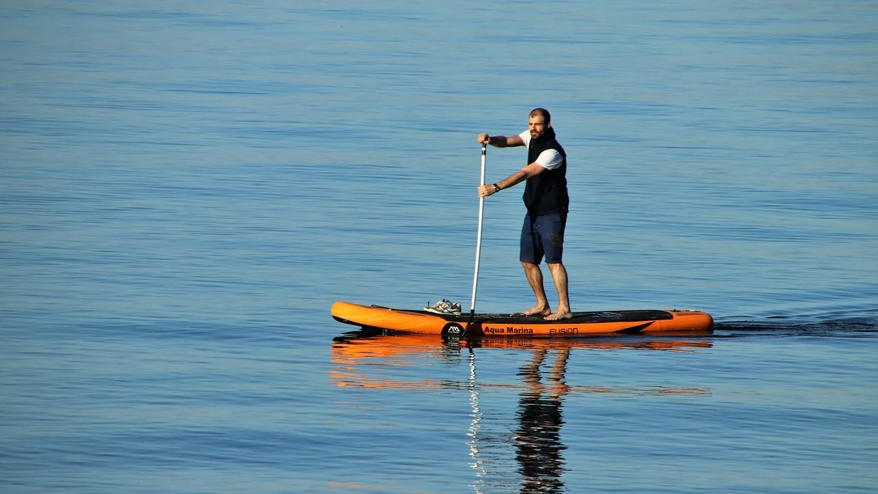 Stand-up paddle board in calm water with clear visibility of board and paddle