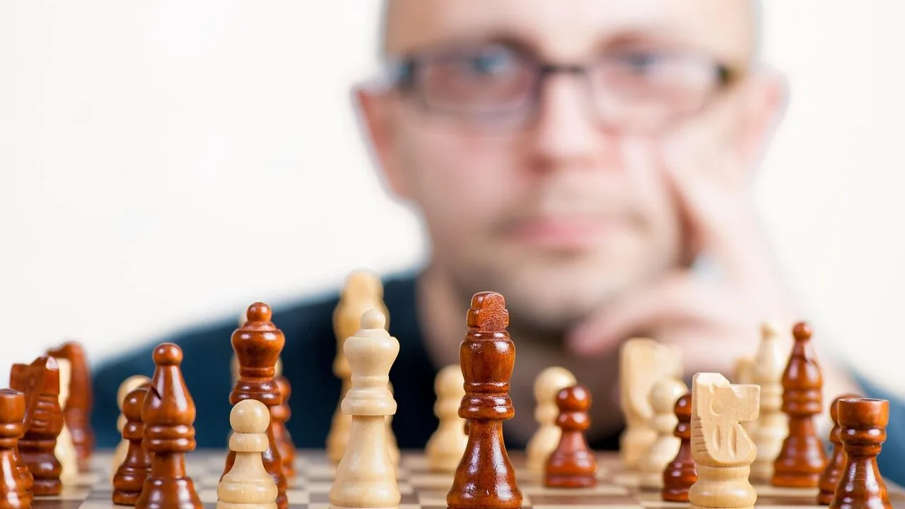 Strategy board games with pieces and cards displayed on wooden table