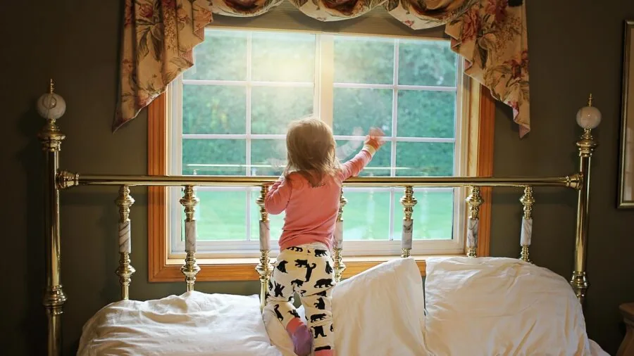 Sunlight filtering through sheer curtains in a bedroom, demonstrating natural light control and window treatment functionality