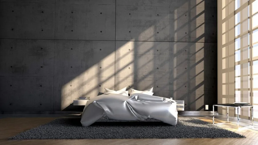Sunlight streaming through bedroom window creating natural light and shadow patterns on wall