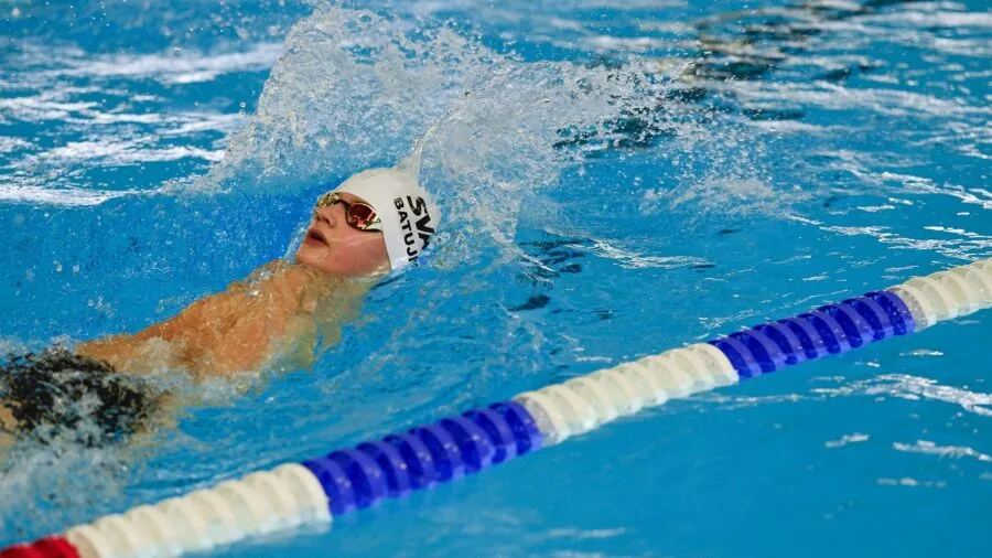 Swimmer doing freestyle stroke during pool training session
