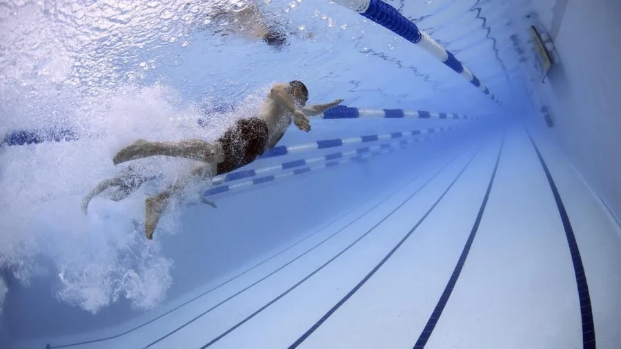 Swimmer's underwater view looking ahead in pool with clear water visibility
